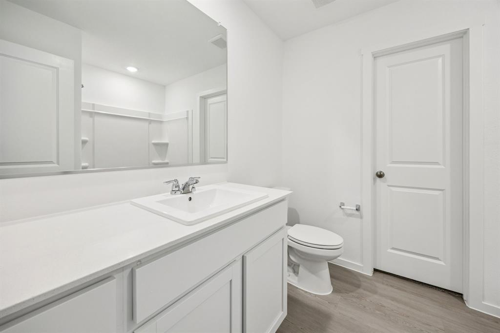 11550 Gammon Avenue Rhome, TX 76078 - Photo 19 of 29 a bathroom with a sink a toilet and a mirror