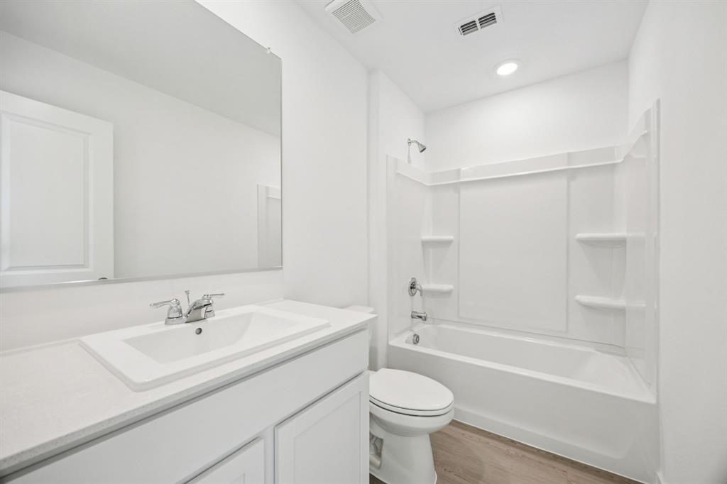 11550 Gammon Avenue Rhome, TX 76078 - Photo 25 of 29 a bathroom with a sink toilet a mirror and shower