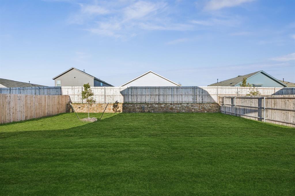 11550 Gammon Avenue Rhome, TX 76078 - Photo 27 of 29 a front view of a house with garden