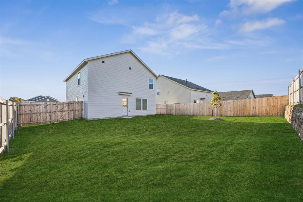 11550 Gammon Avenue Rhome, TX 76078 - Photo 29 of 29 a view of a backyard with wooden fence