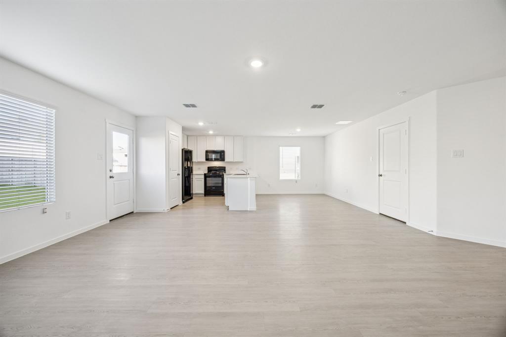 11550 Gammon Avenue Rhome, TX 76078 - Photo 8 of 29 a view of an empty room with a kitchen