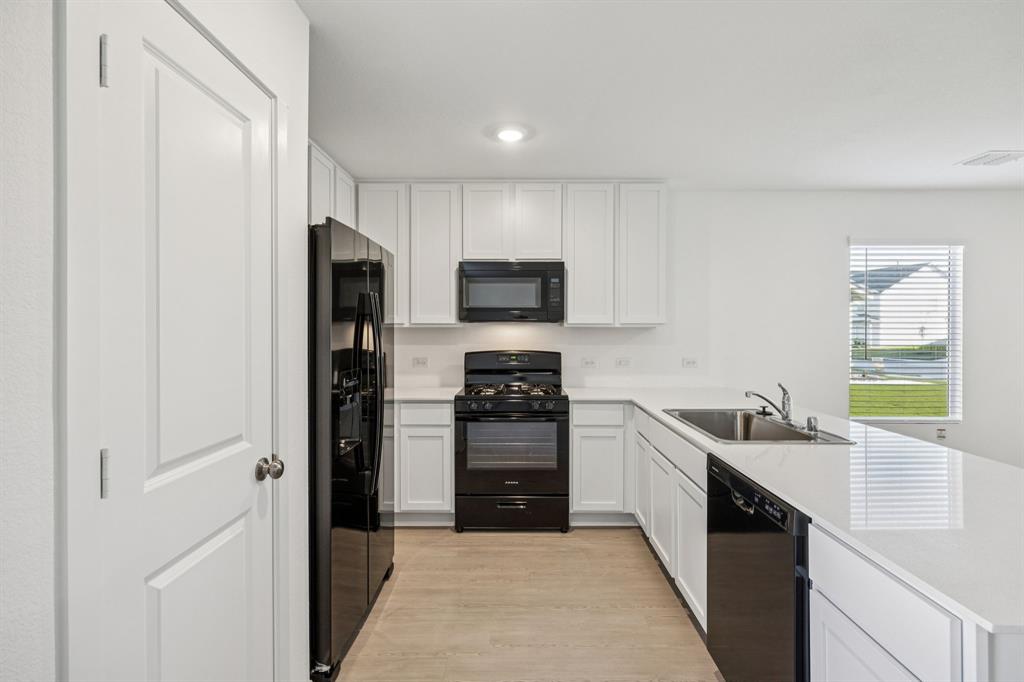 11550 Gammon Avenue Rhome, TX 76078 - Photo 9 of 29 a kitchen with a refrigerator and a sink