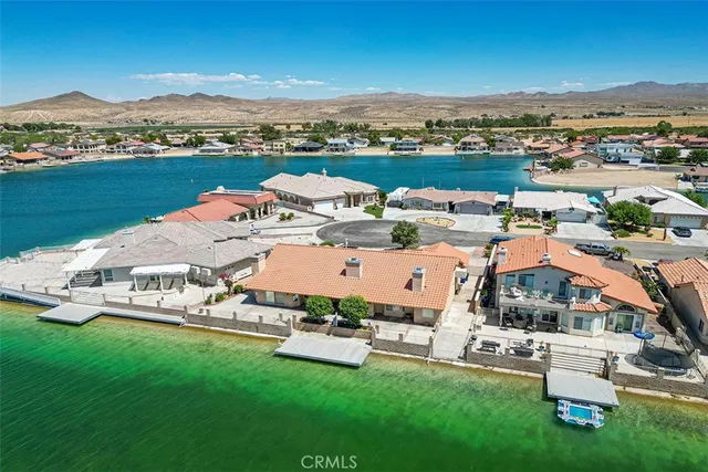 an aerial view of a swimming pool with lounge chairs