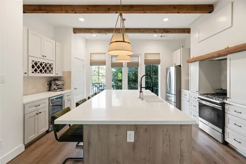 a kitchen with a stove a sink and a refrigerator