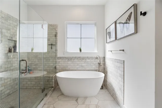a bathroom with a bathtub and shower