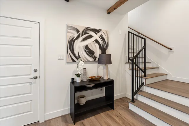 a view of hallway with wooden floor