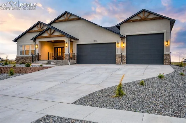 a front view of a house with garage and yard
