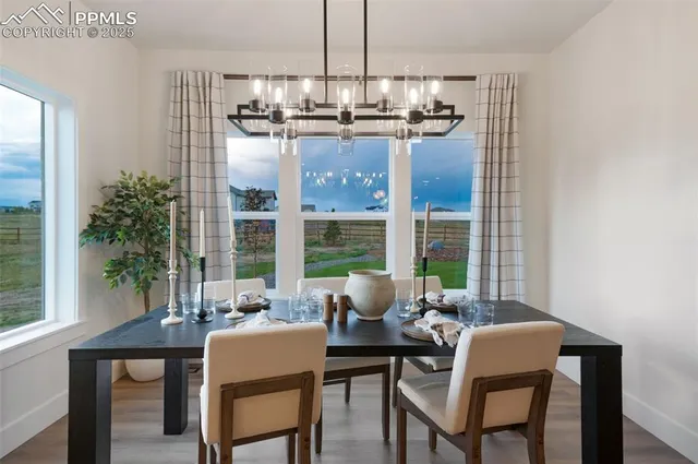 a dining room with furniture a chandelier and window