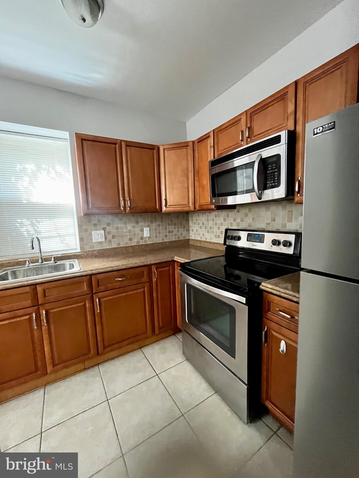 7106 Devon Street, Unit 1 Philadelphia, PA 19119 - Photo 11 of 11 Modern kitchen with warm wood tones.