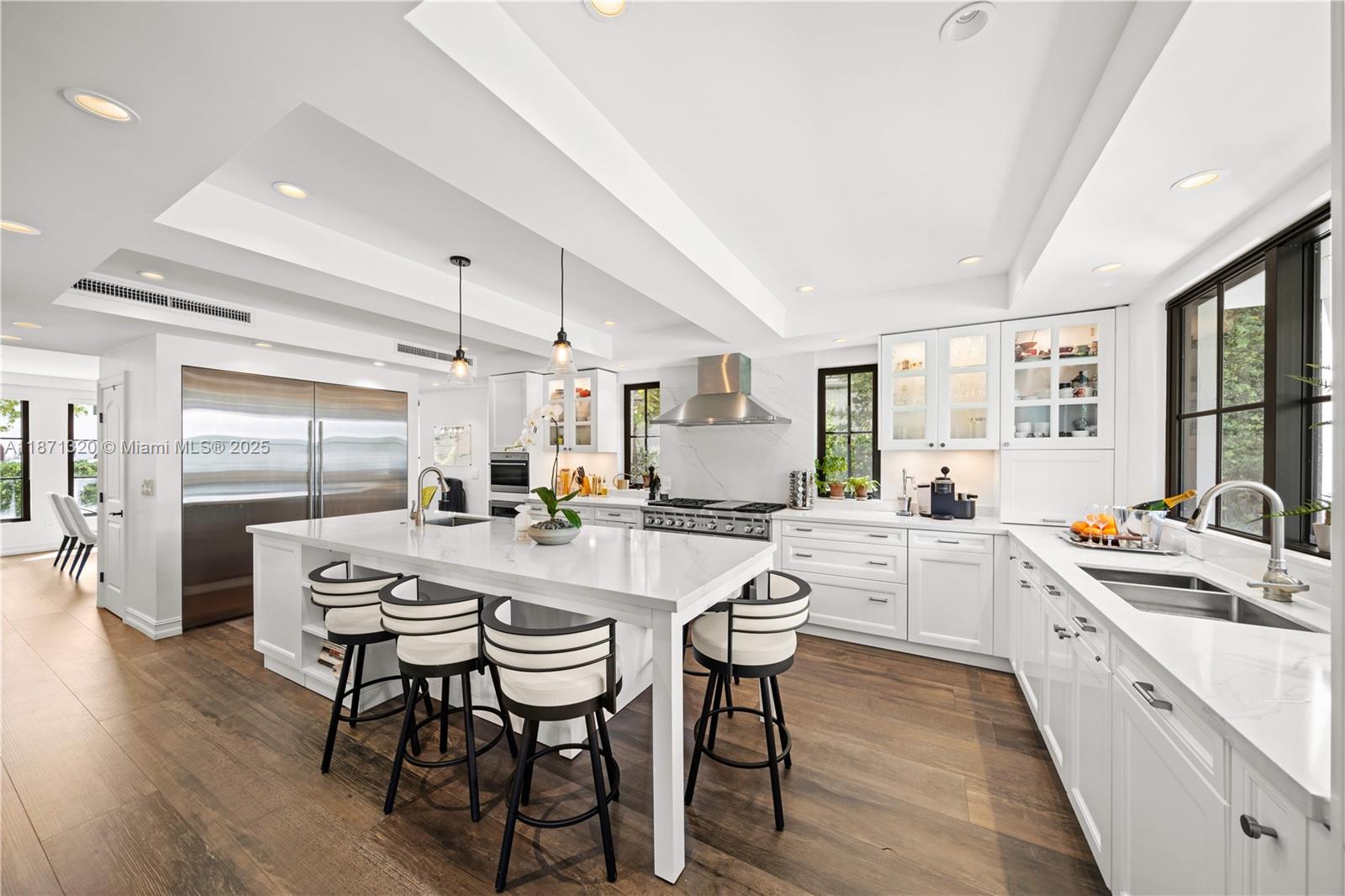 5728 Pine Tree Drive Miami Beach, FL 33140 - Photo 11 of 49 a large kitchen with a table and chairs