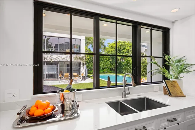 a view of a dining room with furniture large windows and wooden floor