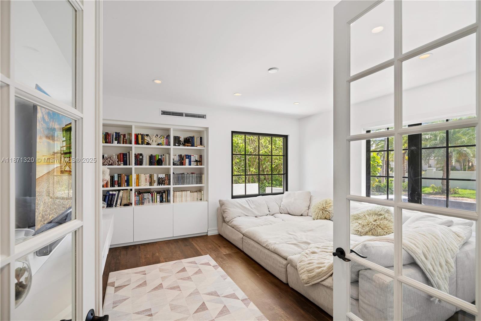 5728 Pine Tree Drive Miami Beach, FL 33140 - Photo 18 of 49 a spacious bedroom with a large bed and a large window