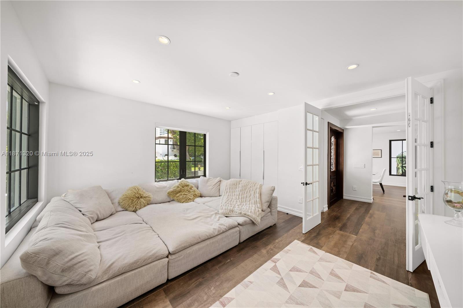 5728 Pine Tree Drive Miami Beach, FL 33140 - Photo 19 of 49 a spacious bedroom with a large bed and a couch