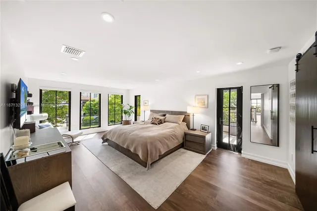 a spacious bedroom with a large bed and a large window