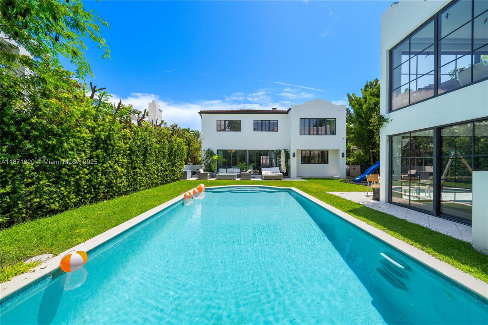 5728 Pine Tree Drive Miami Beach, FL 33140 - Photo 2 of 49 a view of house with swimming pool yard and outdoor seating