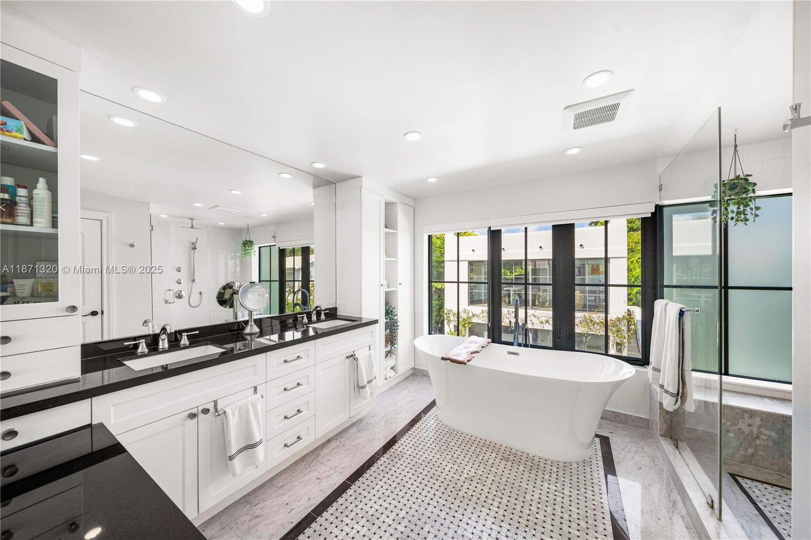 5728 Pine Tree Drive Miami Beach, FL 33140 - Photo 23 of 49 a large bathroom with a large tub and sink
