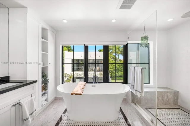 a view of walk in closet with wooden floor and windows
