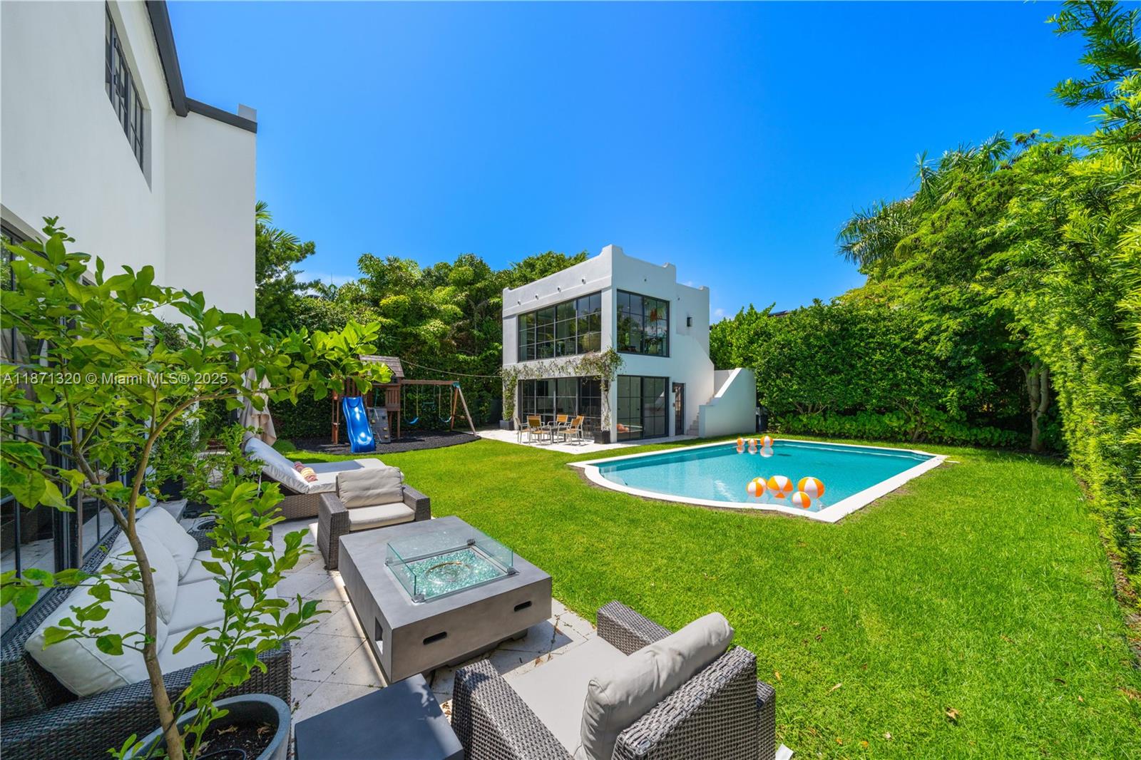 5728 Pine Tree Drive Miami Beach, FL 33140 - Photo 32 of 49 a view of a house with a backyard space and sitting area