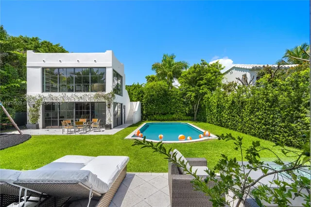 a view of a house with a yard patio and a slide