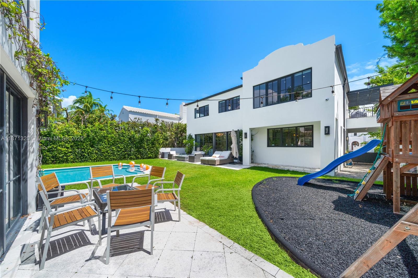 5728 Pine Tree Drive Miami Beach, FL 33140 - Photo 34 of 49 a view of a house with a yard patio and a slide