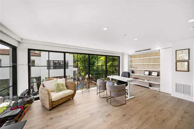 a view of a dining room with furniture water view and a flat screen tv