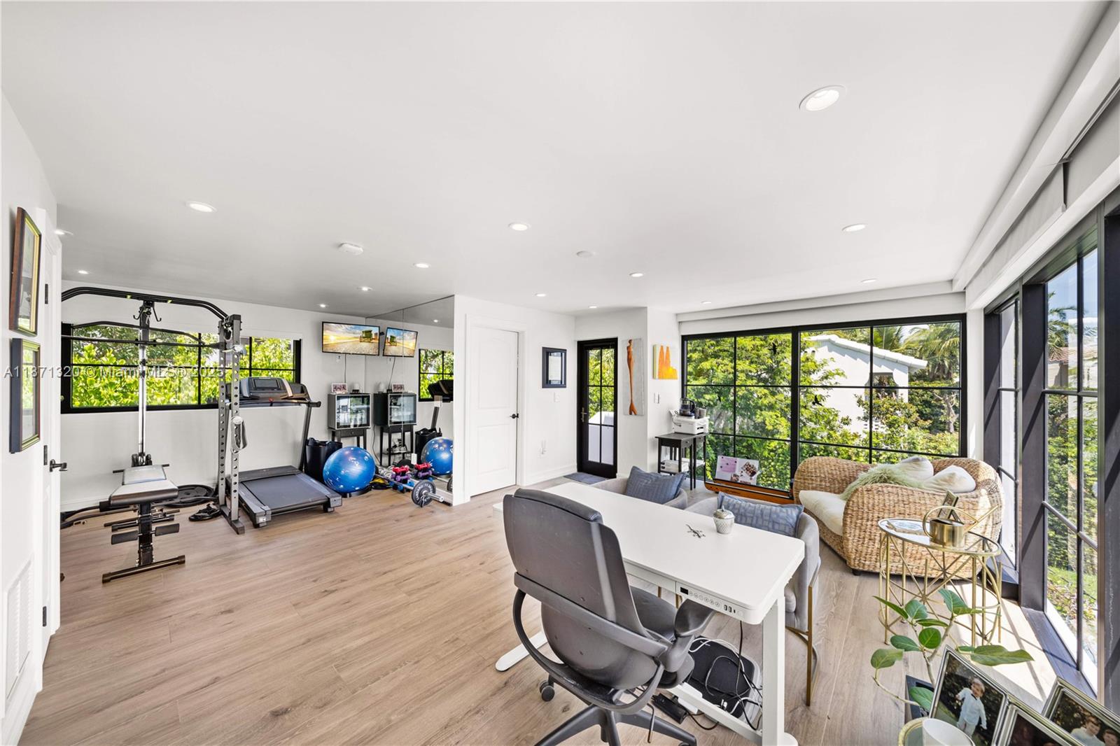 5728 Pine Tree Drive Miami Beach, FL 33140 - Photo 41 of 49 a view of a dining room with furniture water view and a flat screen tv