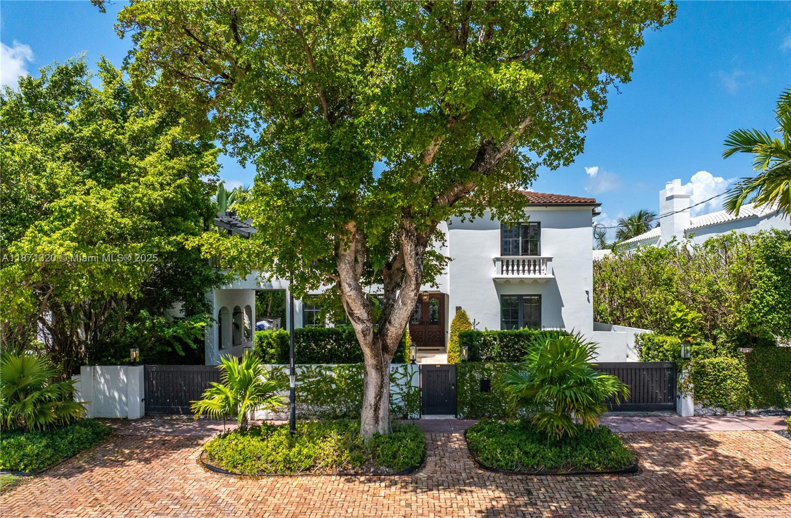 5728 Pine Tree Drive Miami Beach, FL 33140 - Photo 44 of 49 a front view of a house with garden