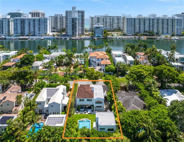 an aerial view of residential house with outdoor space and trees all around