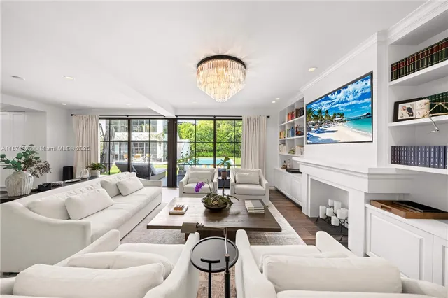 a living room with furniture and a floor to ceiling window