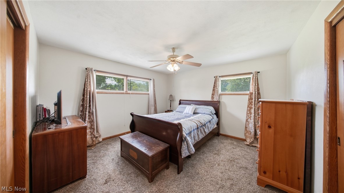 89 Dagg Road Parkersburg, WV 26101 - Photo 27 of 45 Carpeted bedroom featuring white walls, a ceiling fan with light fixture, and two windows with wood trim