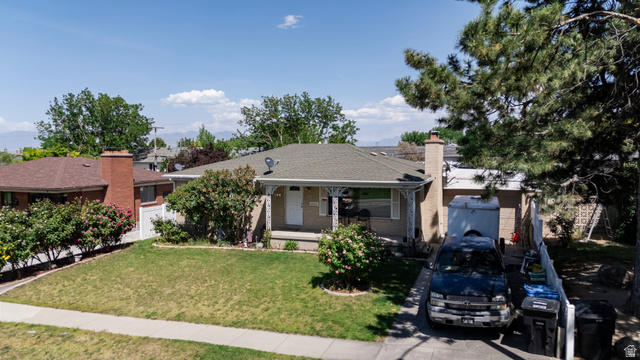 3233 Jean Street Magna, UT 84044 - Photo 33 of 33 Traditional single-story residence featuring a covered front porch, a gabled roof, and a mature front yard