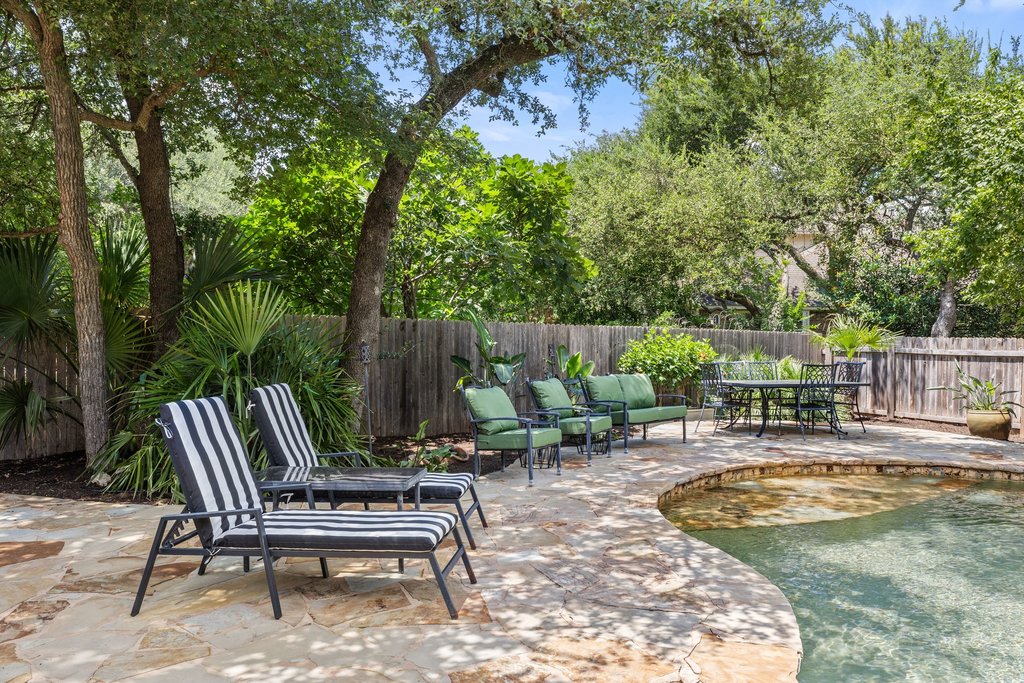 6704 Kiev Cove Austin, TX 78739 - Photo 37 of 37 An inviting backyard oasis offers a free-form pool and ample patio space for leisure and entertainment.