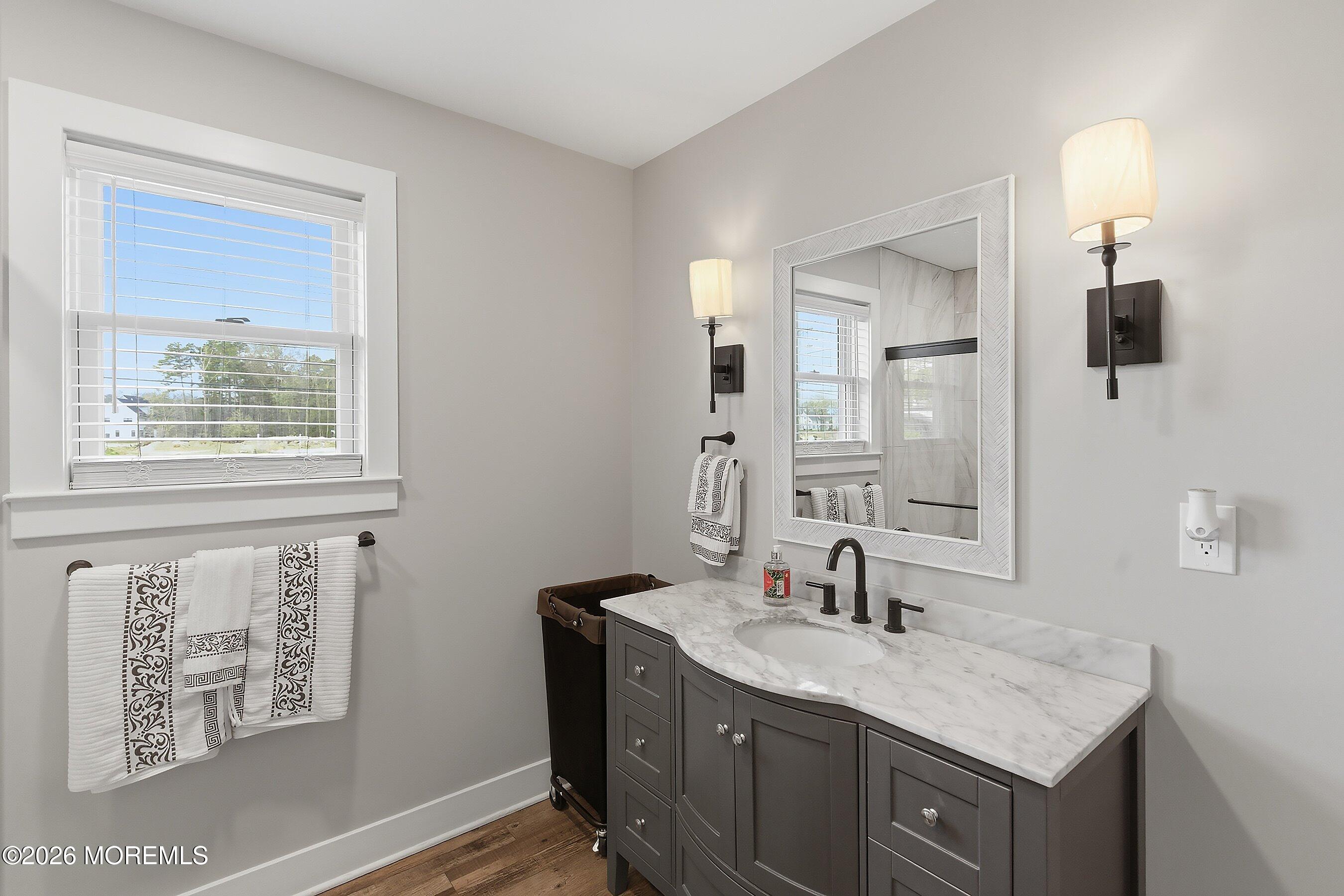 83 Whitesville Road Jackson, NJ 08527 - Photo 14 of 31 a bathroom with a granite countertop sink a mirror and a window