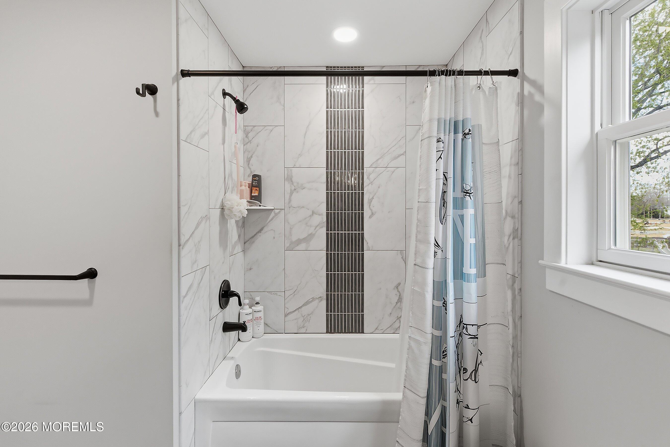 83 Whitesville Road Jackson, NJ 08527 - Photo 18 of 31 a bathroom with a shower curtain and a bathtub