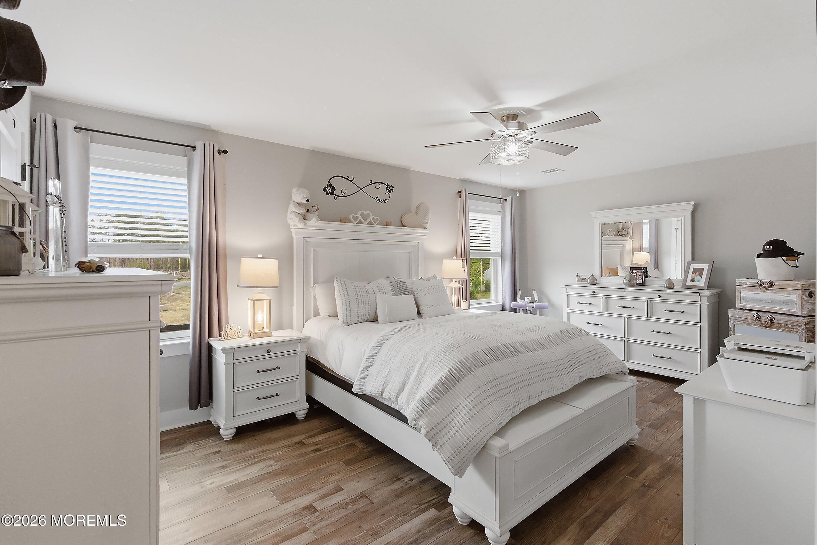 83 Whitesville Road Jackson, NJ 08527 - Photo 19 of 31 a bedroom with a bed and a chandelier
