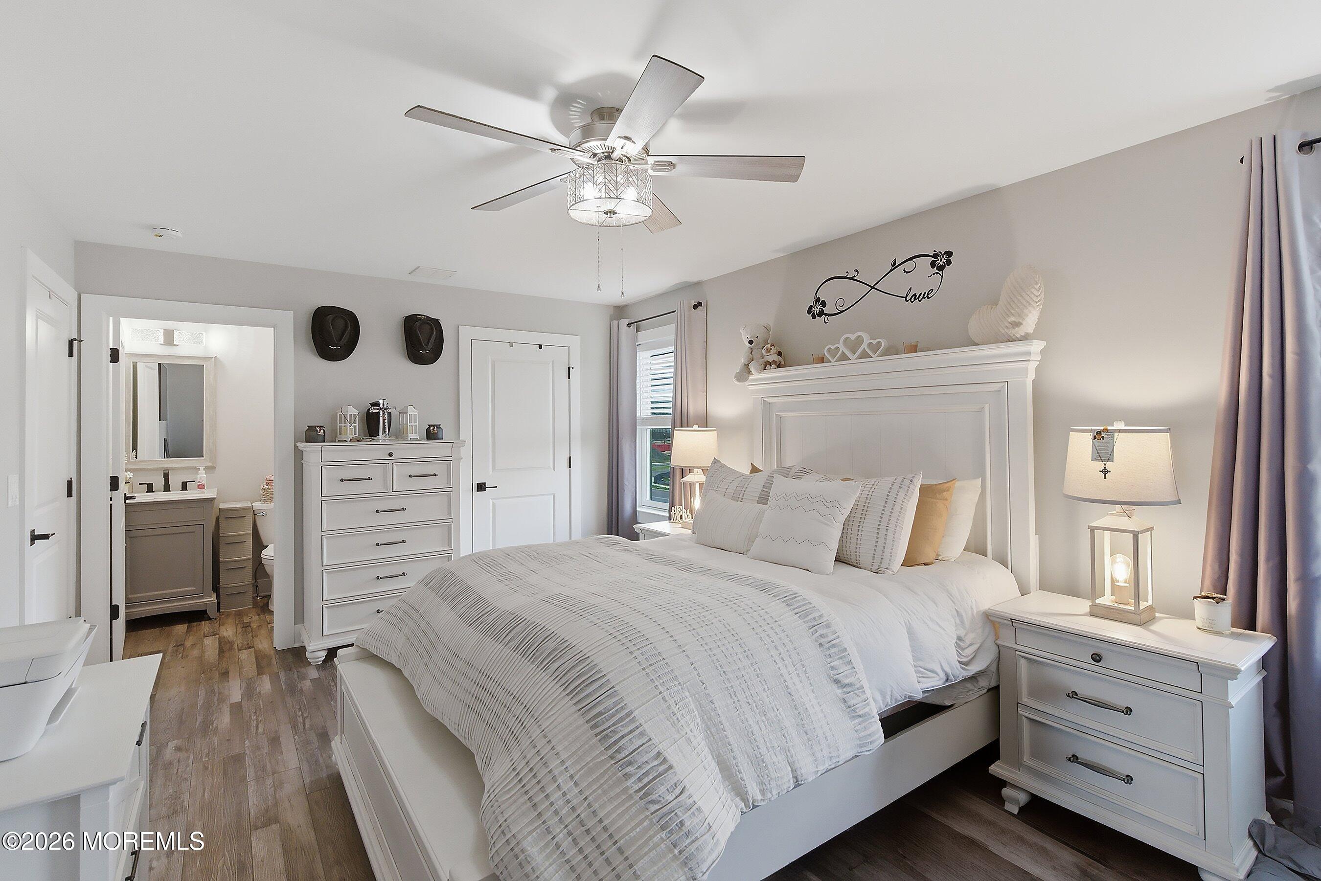 83 Whitesville Road Jackson, NJ 08527 - Photo 20 of 31 a bedroom with a bed and a chandelier
