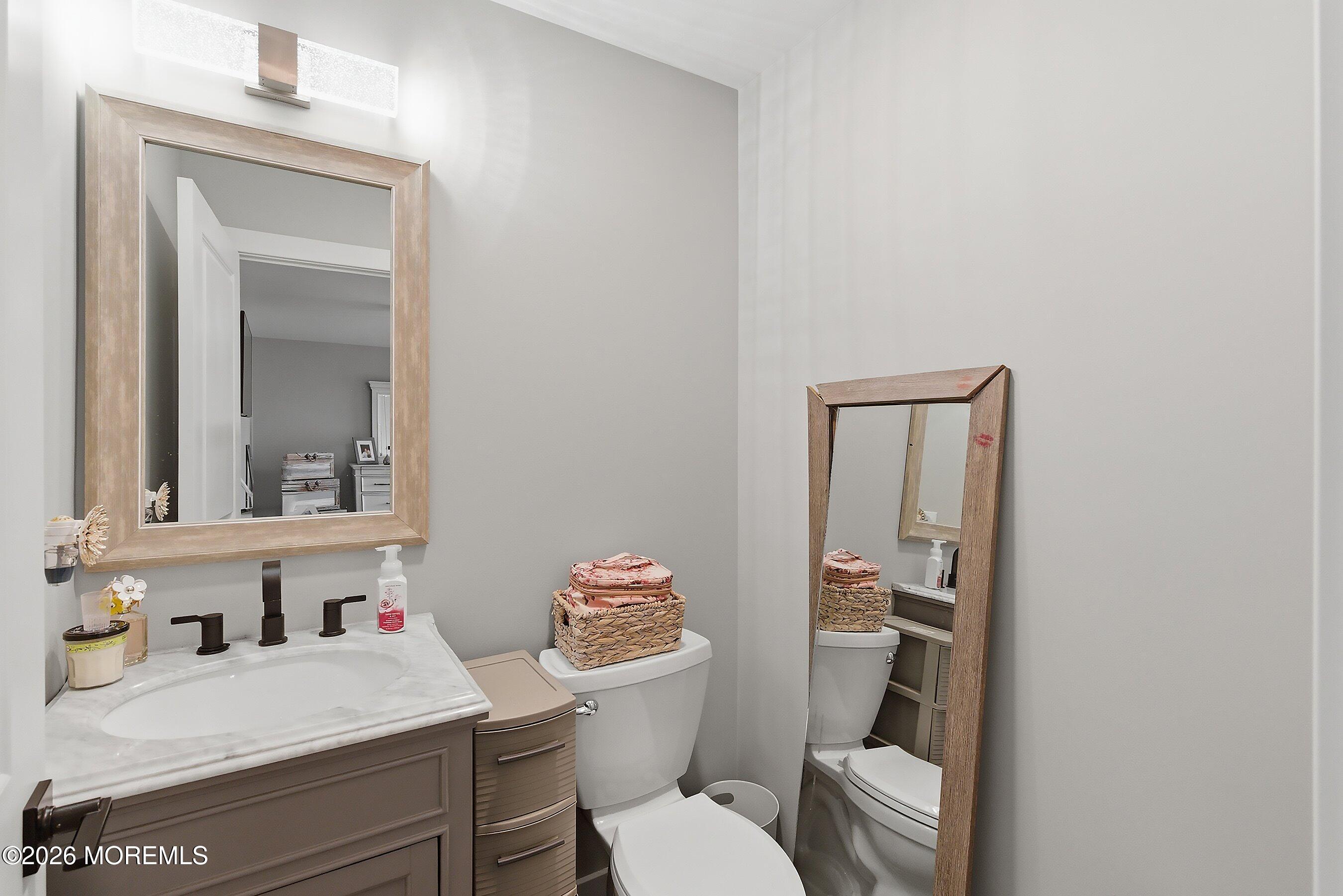 83 Whitesville Road Jackson, NJ 08527 - Photo 21 of 31 a bathroom with a toilet sink vanity and mirror