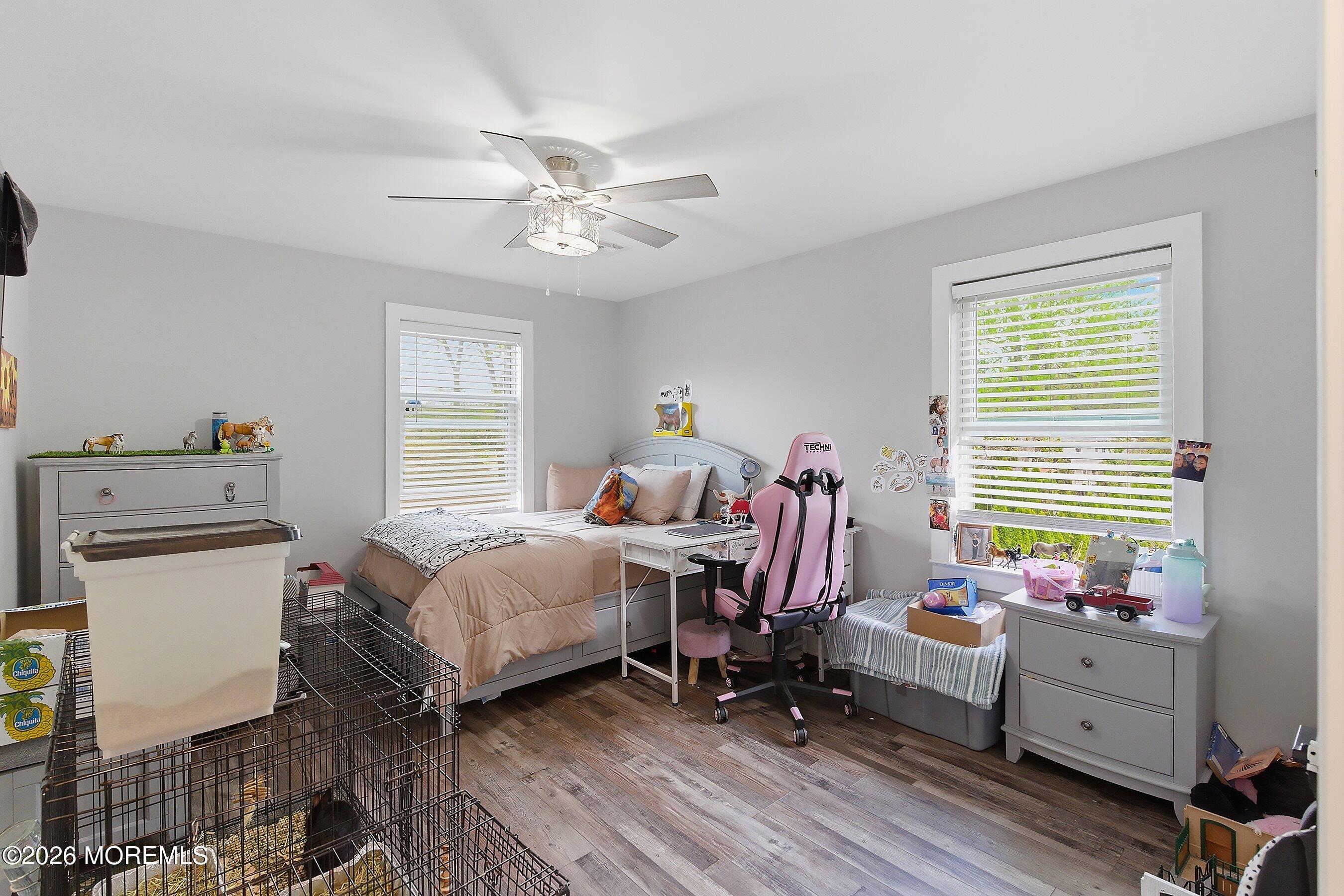 83 Whitesville Road Jackson, NJ 08527 - Photo 22 of 31 a bed room with a bed and a chandelier