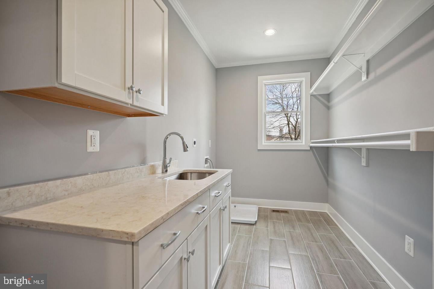 8616 Jones Mill Road Chevy Chase, MD 20815 - Photo 44 of 81 Large laundry with with cabinets & custom shelvimg