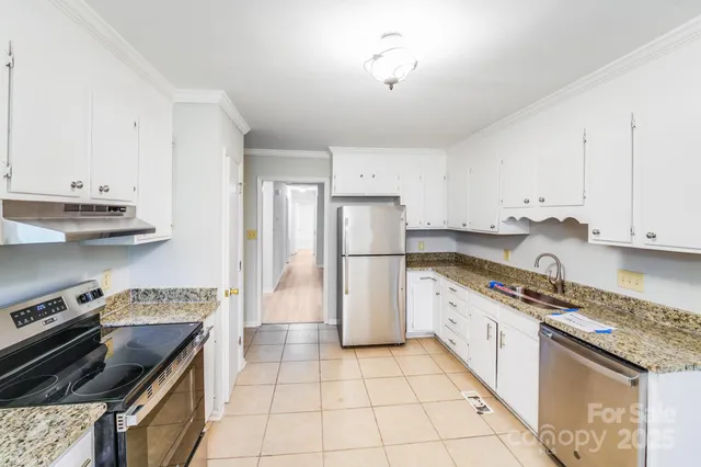 a kitchen with a stove sink and refrigerator