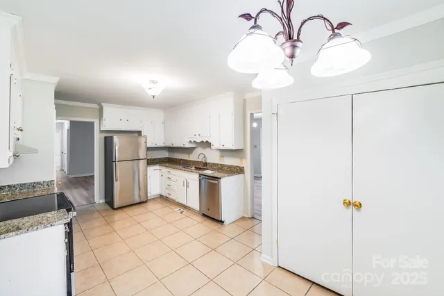 a kitchen with granite countertop a stove a sink and a granite counter tops