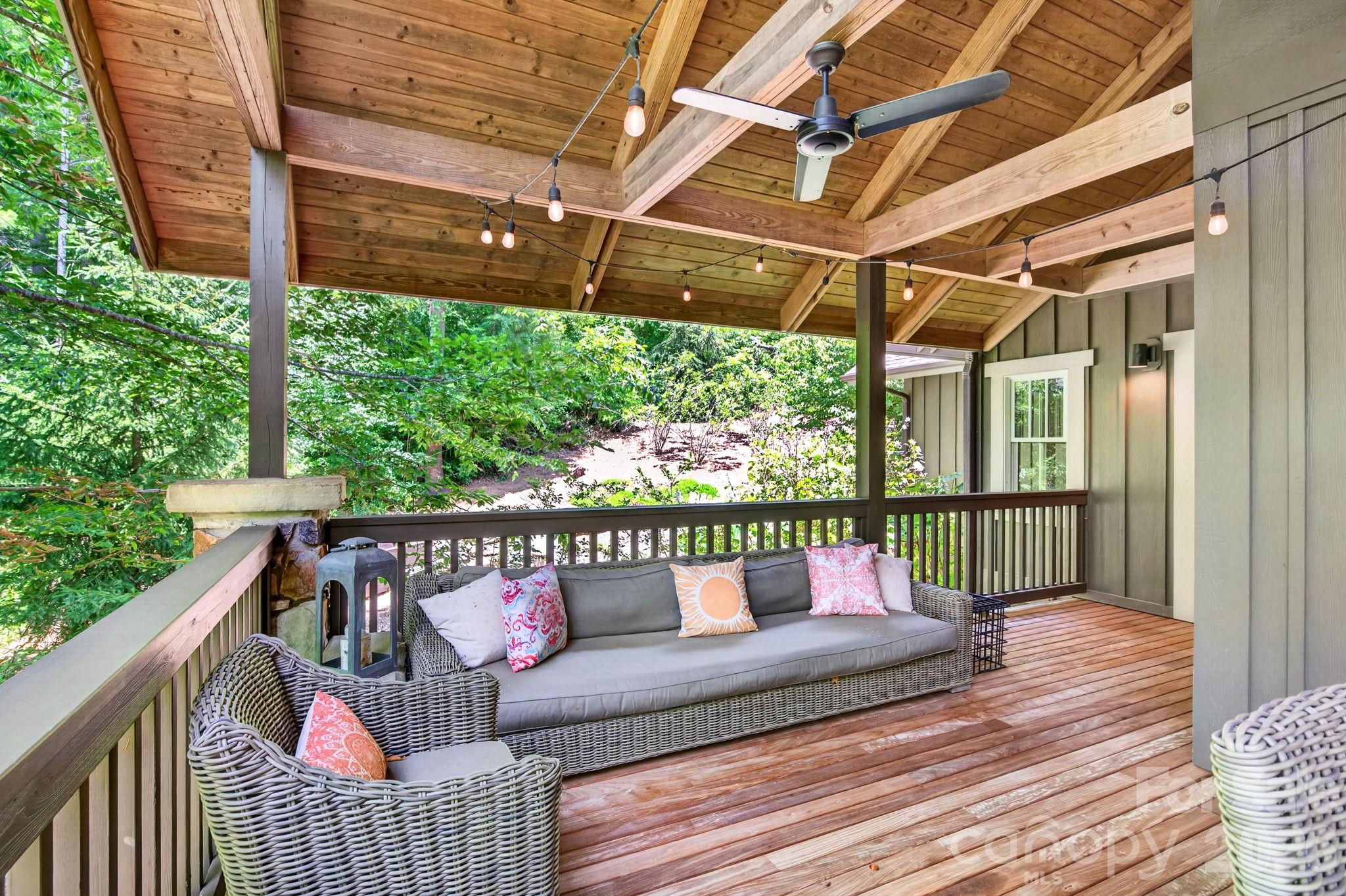235 Bull Creek Road Asheville, NC 28805 - Photo 18 of 47 a roof deck with wooden floor and outdoor seating