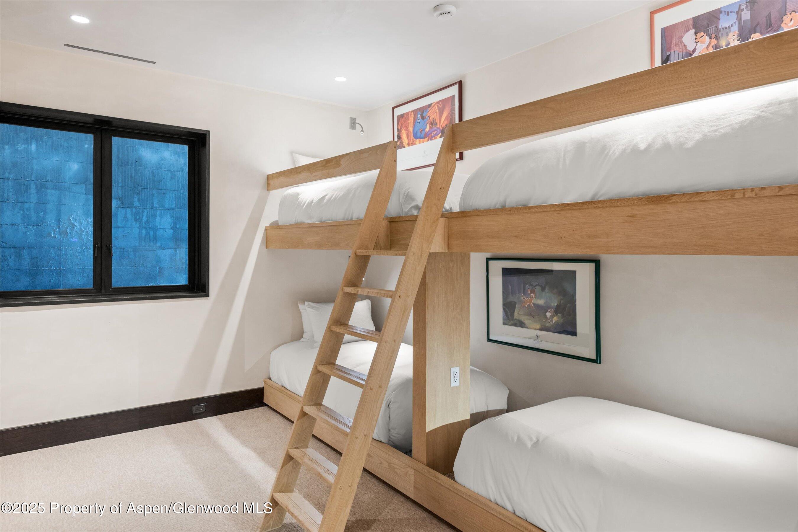 1422 West Buttermilk Road Aspen, CO 81611 - Photo 29 of 39 a bedroom with a bed and a painting on the wall