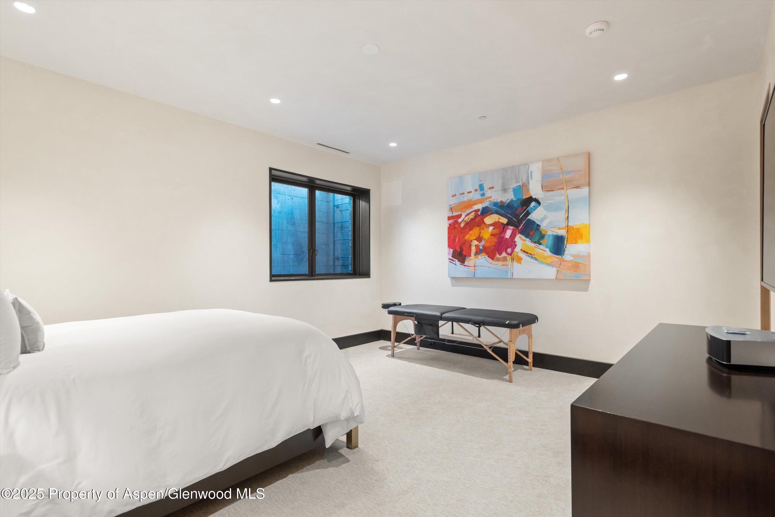 1422 West Buttermilk Road Aspen, CO 81611 - Photo 31 of 39 a bedroom with a bed and painting on the wall