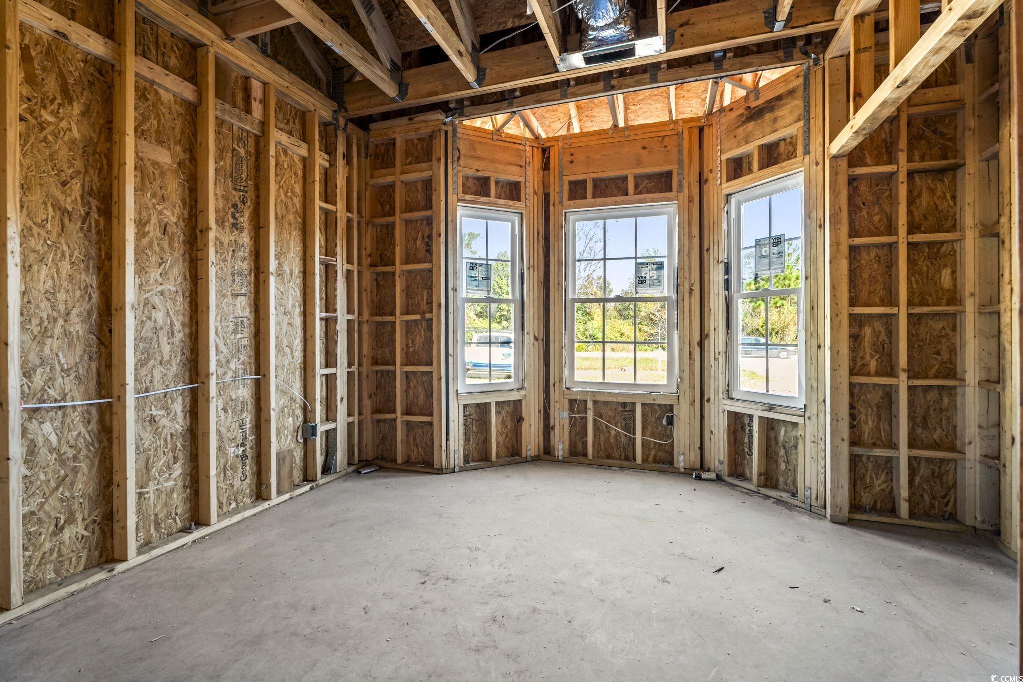 2090 Highway 9 Business Loris, SC 29569 - Photo 8 of 19 1 of 3 guest bedrooms featuring carpet flooring, bump out windows, modern crown molding, and a spacious closet. This room is closest to the front door and could be used as a office as well!