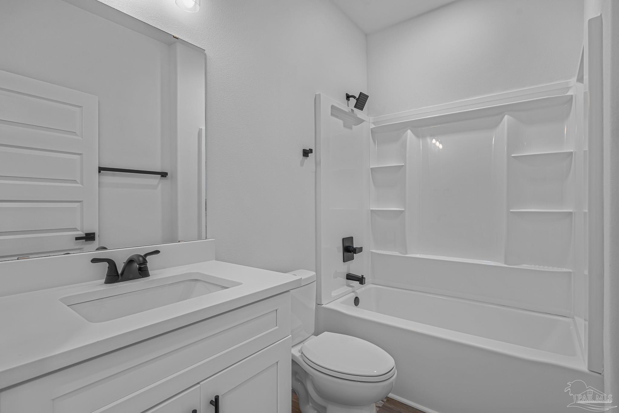 5005 Saufley Field Road Pensacola, FL 32526 - Photo 20 of 27 a bathroom with a sink a toilet and a bathtub