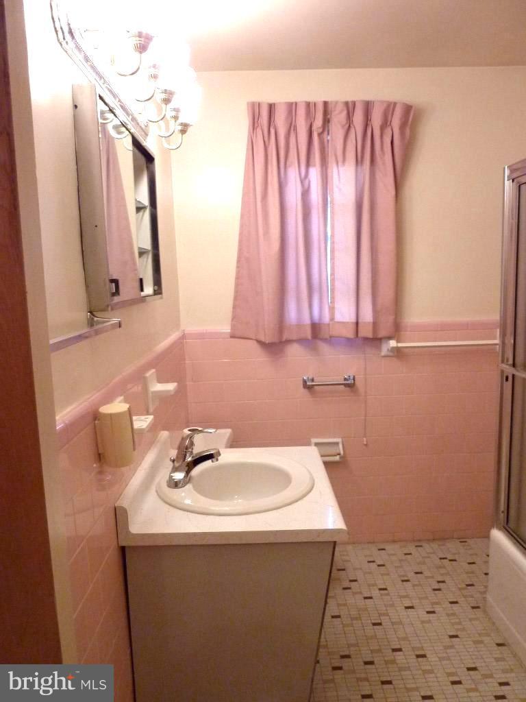 1505 Hamlin Street Northeast Washington, DC 20017 - Photo 13 of 30 a bathroom with a sink a vanity and a mirror