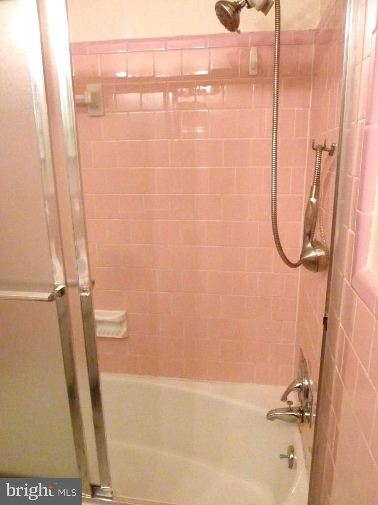 1505 Hamlin Street Northeast Washington, DC 20017 - Photo 14 of 30 a bathroom with a glass shower door