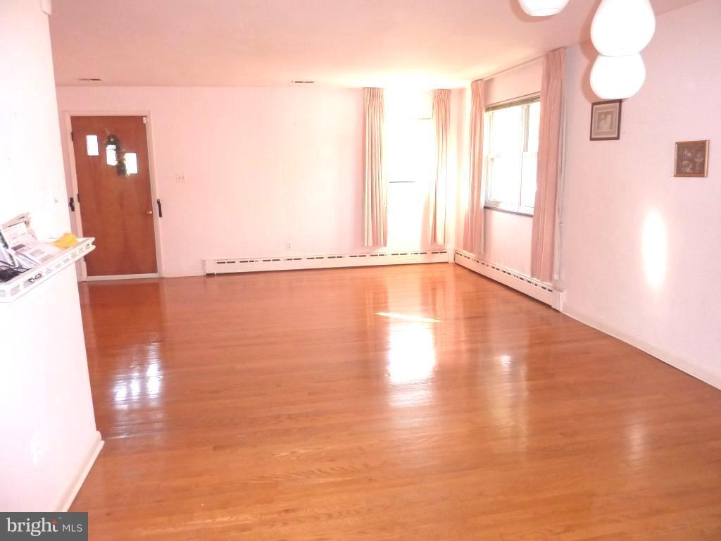 1505 Hamlin Street Northeast Washington, DC 20017 - Photo 5 of 30 a view of a room with wooden floor and windows