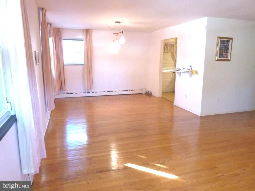 1505 Hamlin Street Northeast Washington, DC 20017 - Photo 6 of 30 a view of a room with wooden floor and a window